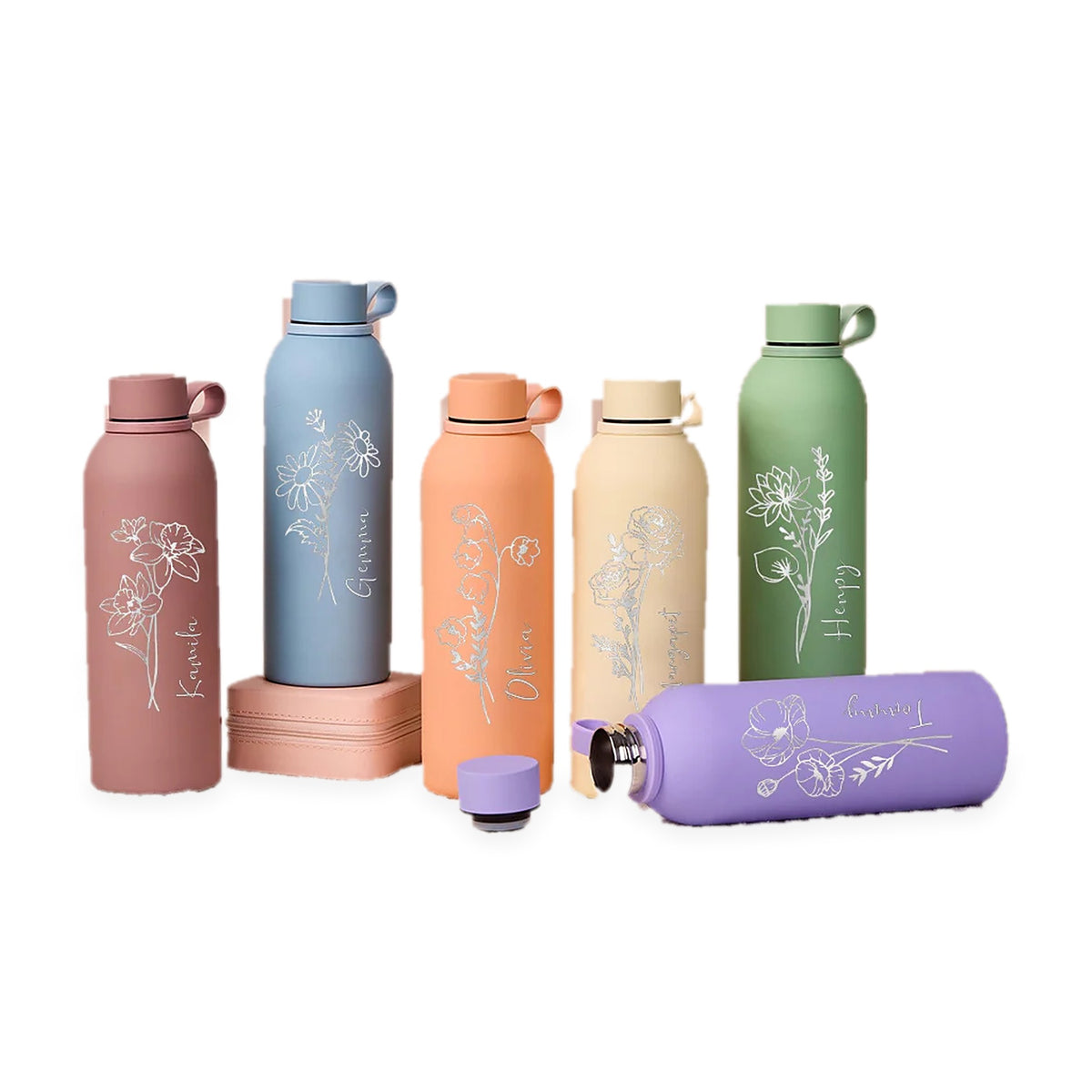 Signature Stories personalised birth flower bottles in dusty rose, sky blue, peach, cream, sage green and lilac